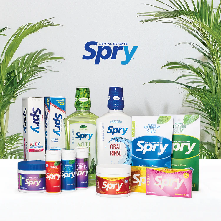 Spry dental products including mouthwash, gum, and other items with a white background and plants.