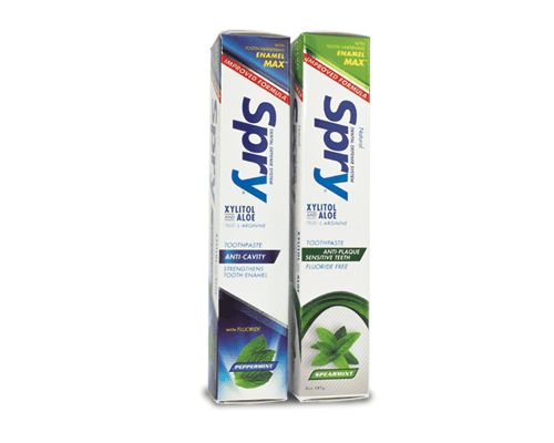 Two boxes of Spry toothpaste with different flavors on a white background